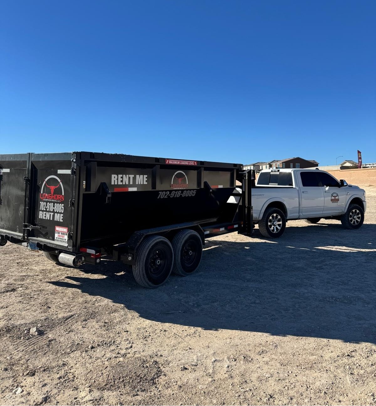 Longhorn truck delivering a reliable roll-off dumpster for rent in Las Vegas.